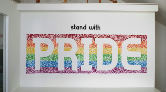 »stand with pride«: More than 3000 paper hearts on a wall. One of the winners of 2017s type with pride contest.